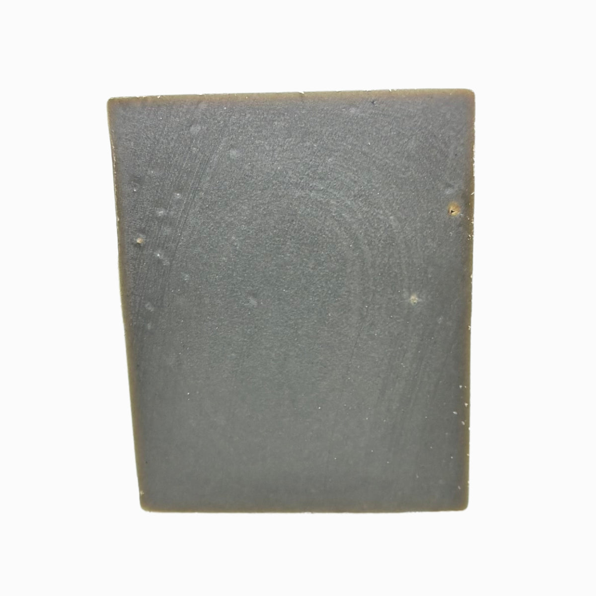 Close-up of Klichy Cinnabomb Natural Soap Bar texture showing mild grit from activated charcoal