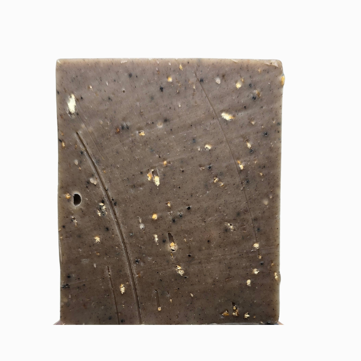 Close-up of Klichy Gritness natural soap bar texture, extreme grit from walnut shells, pumice, and coffee
